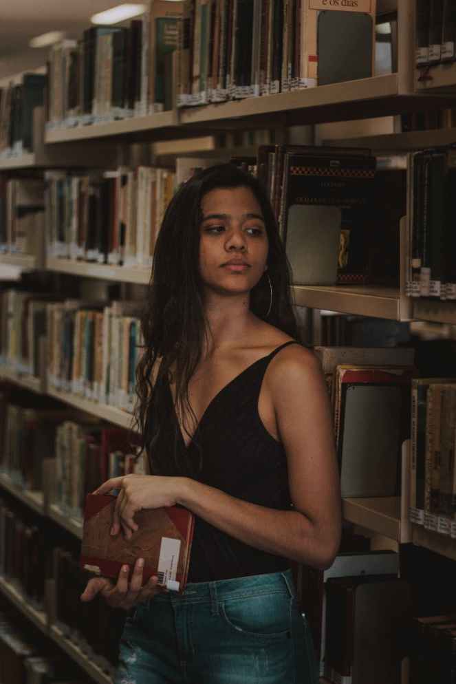 woman in black top holding a book