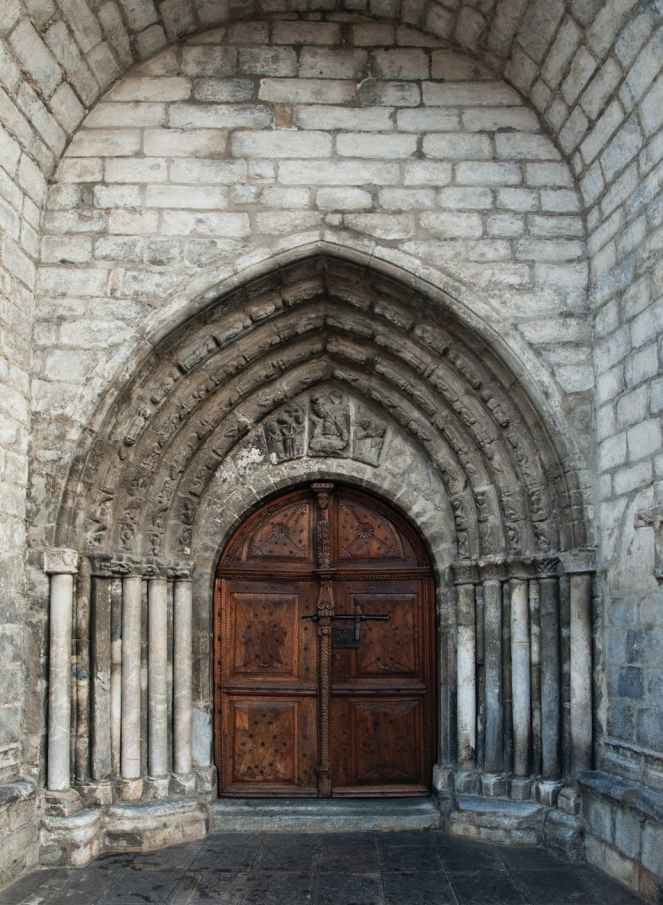 brown wooden door on gray concrete building